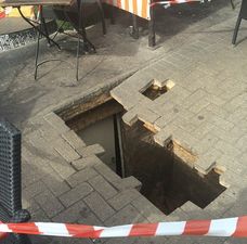 Woman swallowed by huge hole outside café