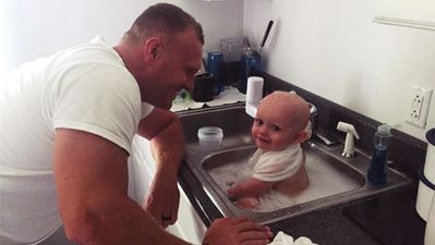 Cop Rescues Baby, Pops Him In The Station Sink For A Quick Bath