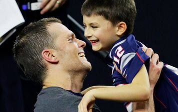 American footballer faces criticism for kissing 11-year-old son on the lips