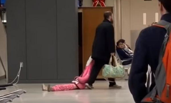 This dad dragging his child through an airport is the most relatable thing we've ever seen
