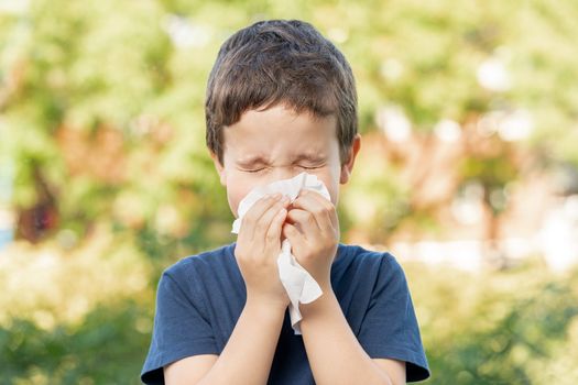 Woman with hayfever, using a tissue