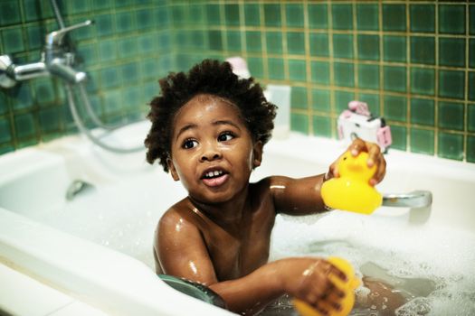 Kid playing with bath toys