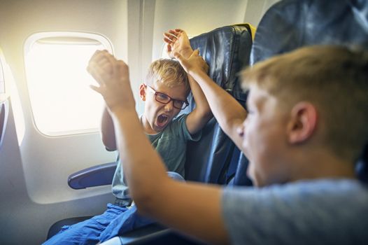 kids fighting on a plane